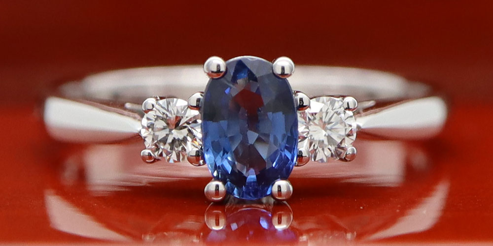 A picture of a ring taken on a shiny wooden background